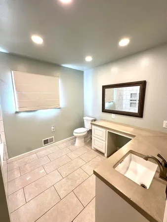 a bedroom with a bed and a night stand