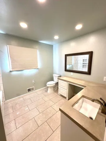 a bedroom with a bed and a night stand