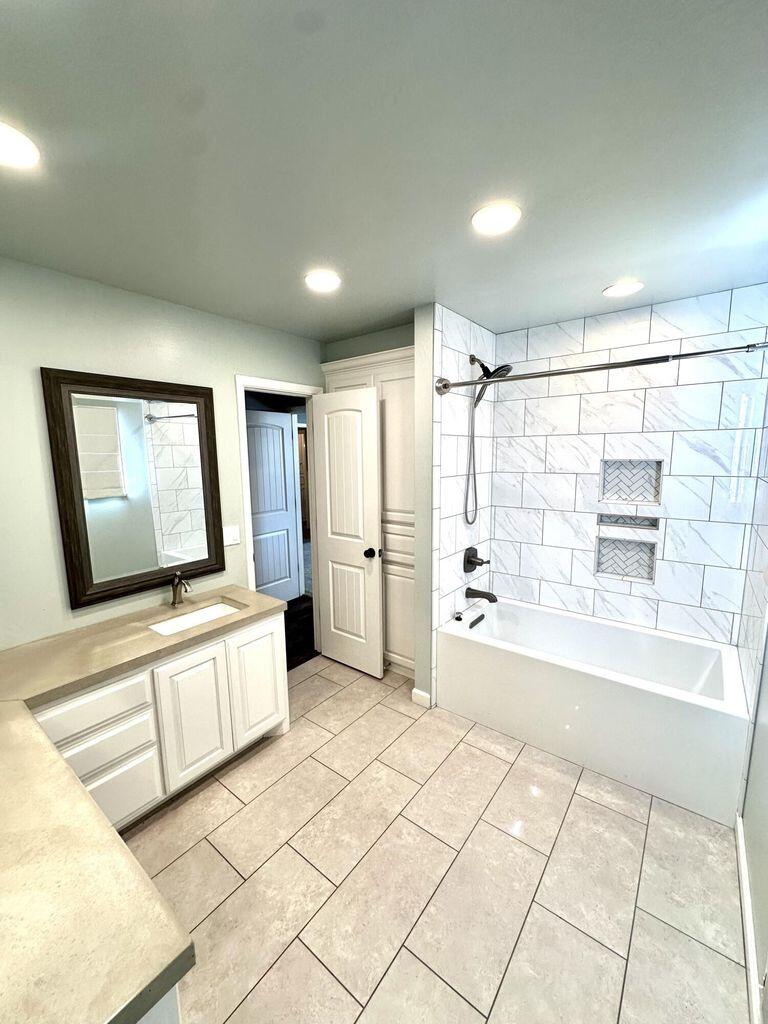 819 Holliday Plainview, TX 79072 - Photo 27 of 38 a bathroom with a large mirror vanity and bathtub