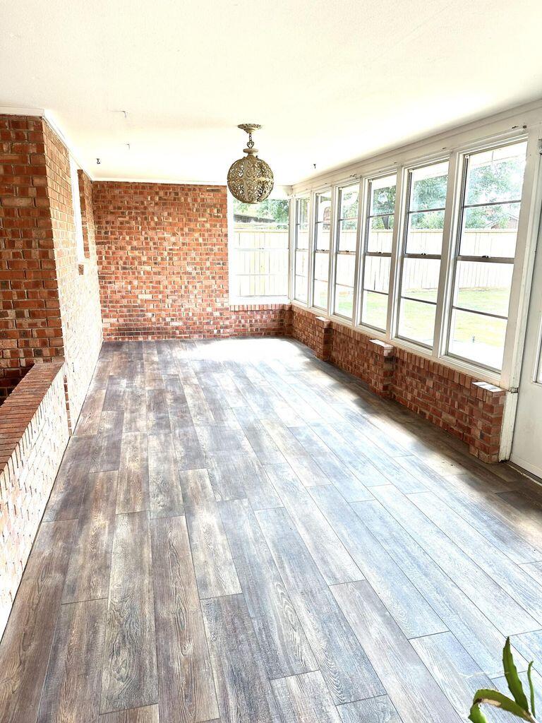 819 Holliday Plainview, TX 79072 - Photo 31 of 38 a view of empty room with wooden floor and fan
