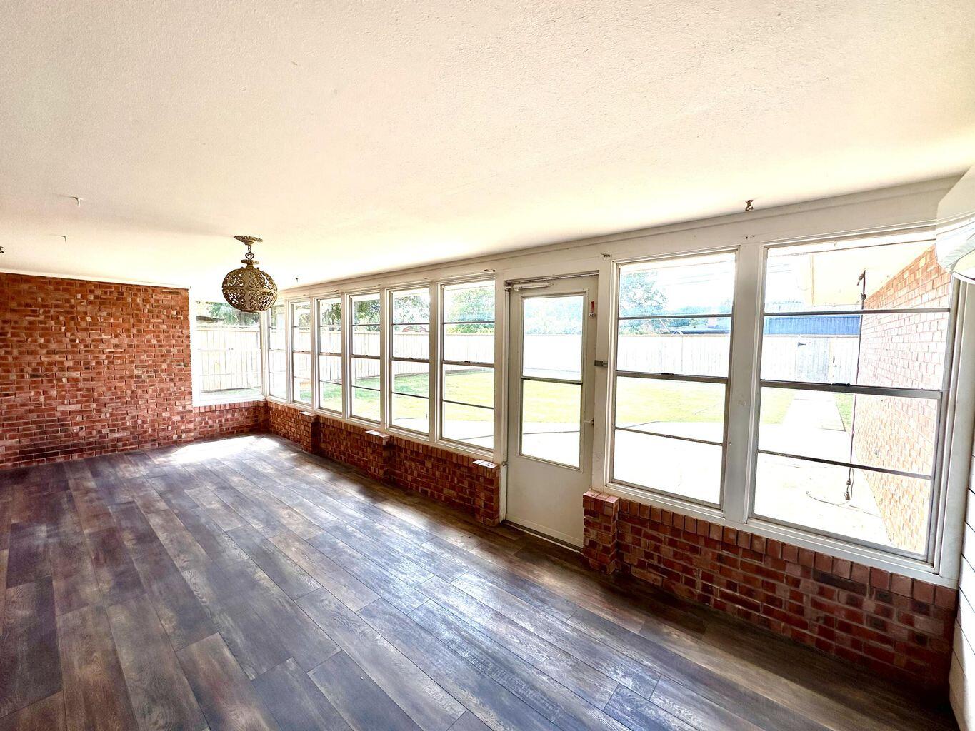 819 Holliday Plainview, TX 79072 - Photo 32 of 38 a view of an empty room with wooden floor and a window