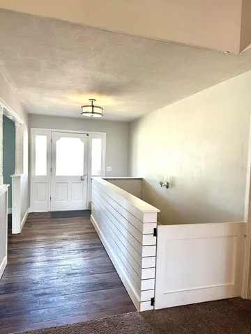 a view of a room with wooden floor and chair