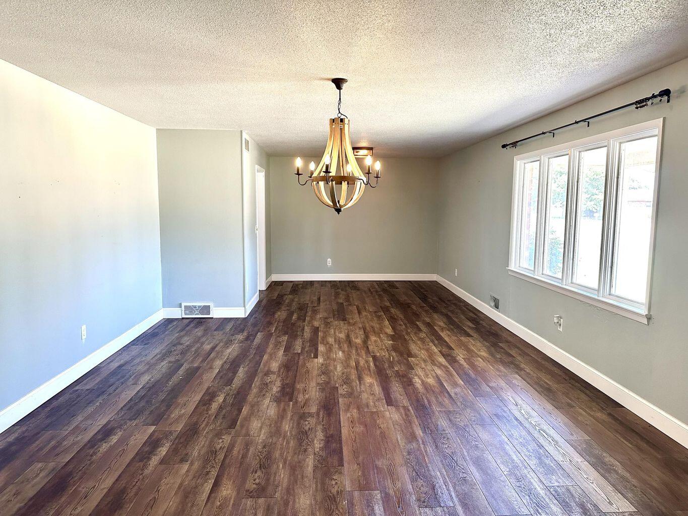 819 Holliday Plainview, TX 79072 - Photo 7 of 38 a view of empty room with wooden floor and fan