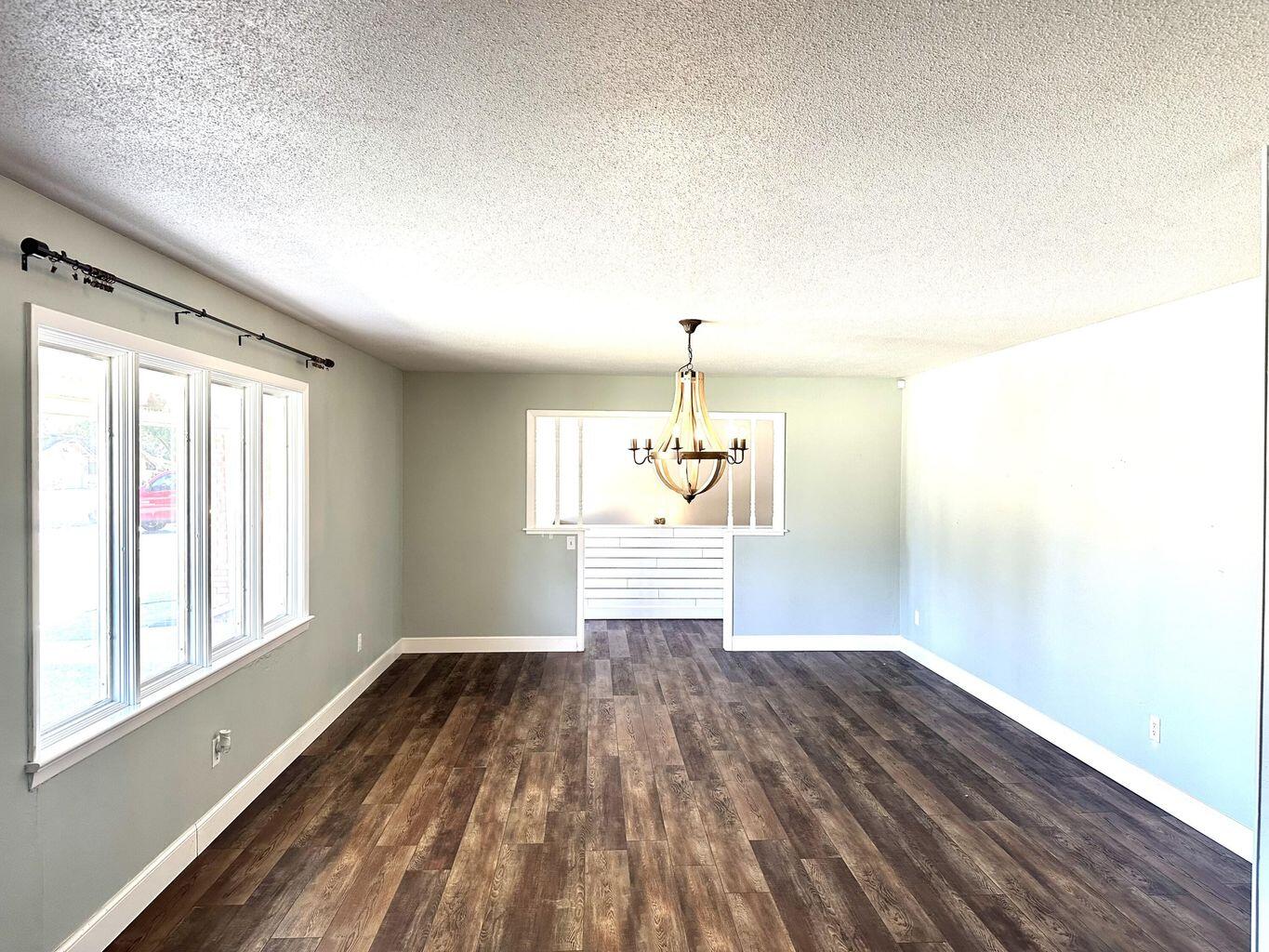 819 Holliday Plainview, TX 79072 - Photo 8 of 38 a view of empty room with wooden floor and fan
