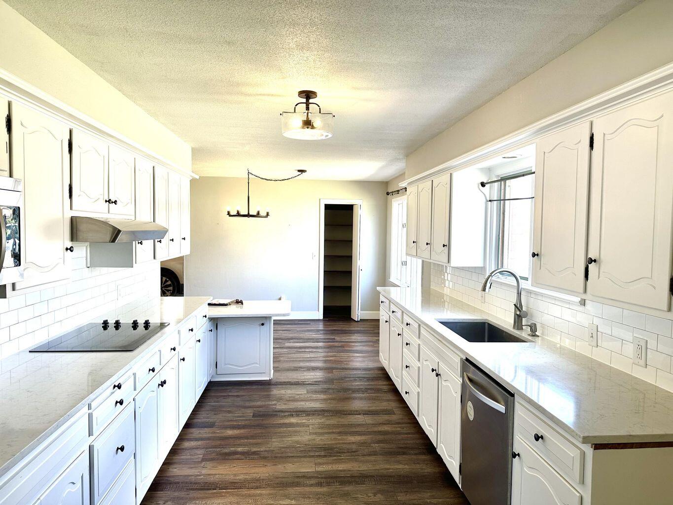 819 Holliday Plainview, TX 79072 - Photo 9 of 38 a large white kitchen with a large window