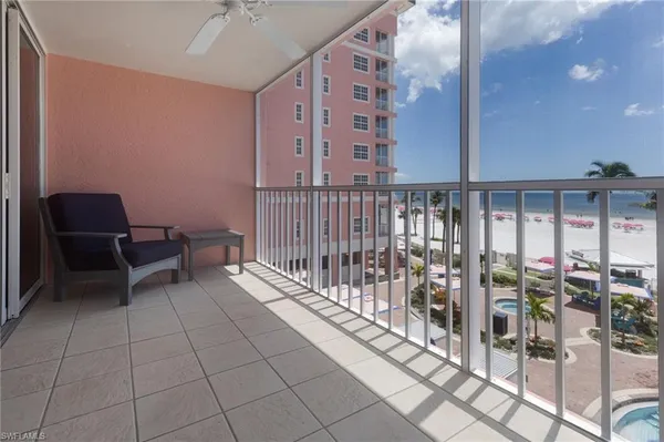 a balcony with chairs and wooden floor