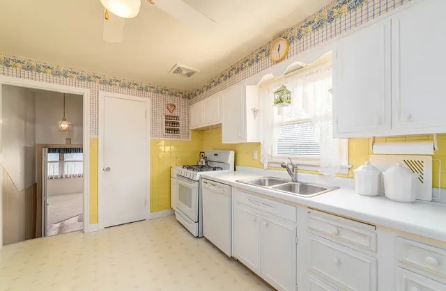 a kitchen with a sink stove and cabinets