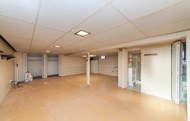 an empty room with a empty space and windows