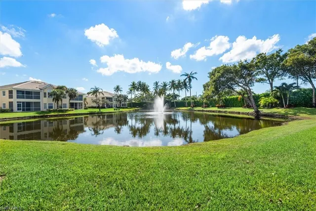 a view of a lake with a house in the background