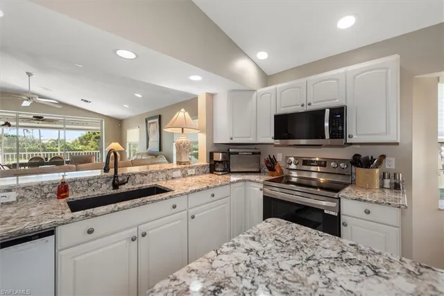 a kitchen with a sink stove and microwave