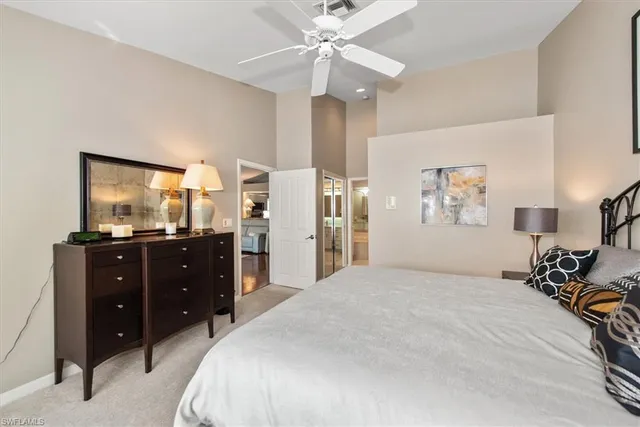 a bedroom with a bed and a mirror on the dresser