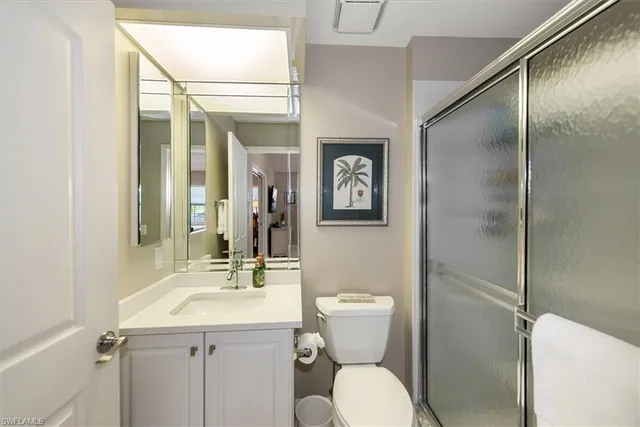 a bathroom with a toilet sink and shower