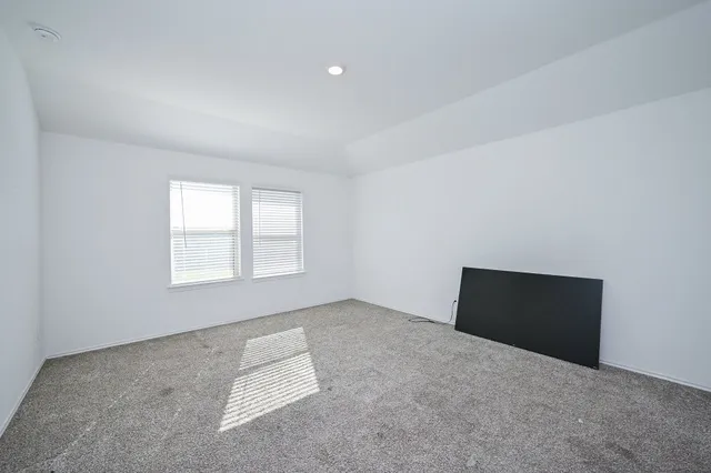 an empty room with a window and pillar in it