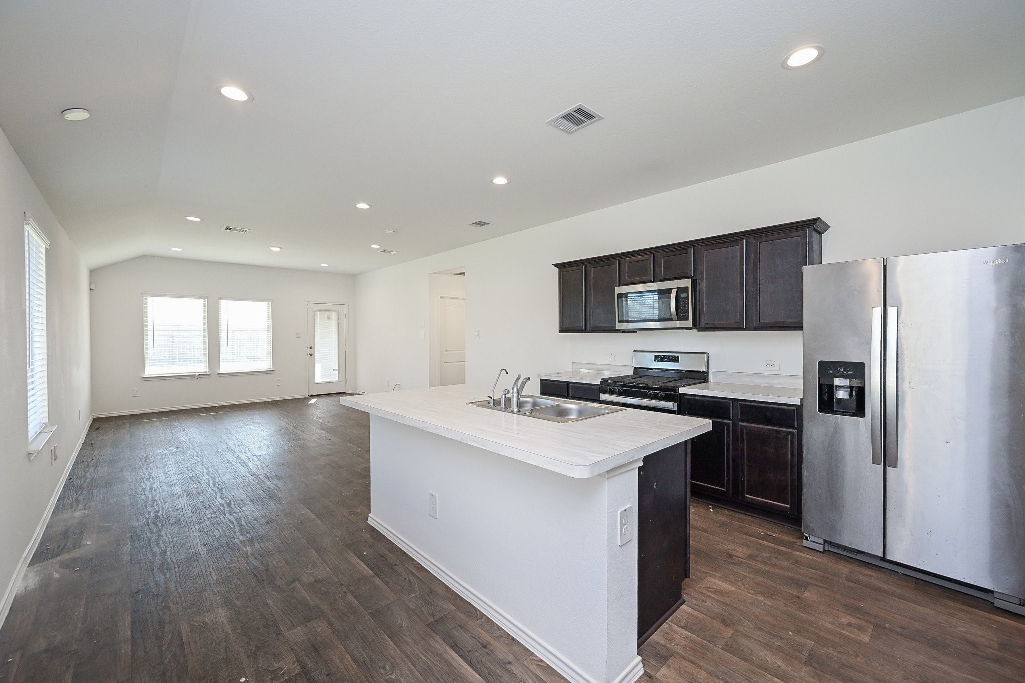 2342 Spruce Clf Lane Spring, TX 77373 - Photo 18 of 32 a kitchen with a sink a microwave a refrigerator and cabinets