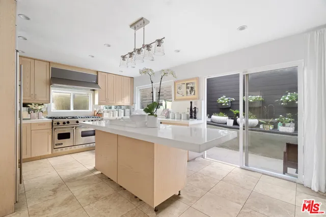 a large white kitchen with cabinets