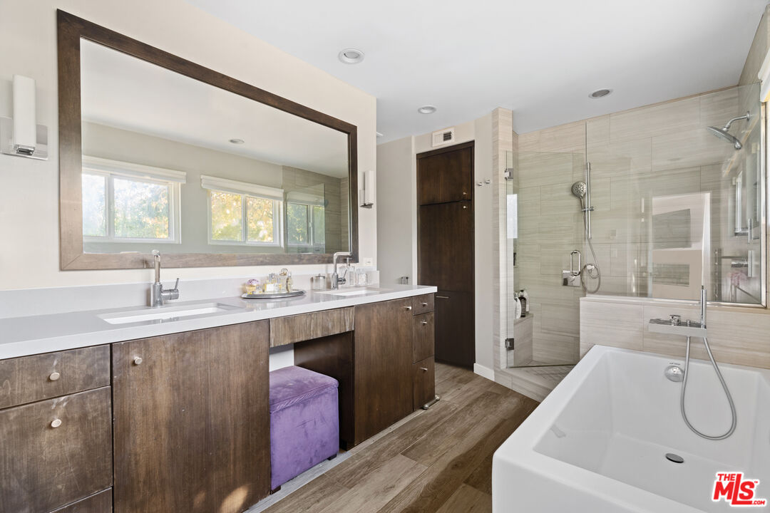 9767 Apricot Lane Beverly Hills, CA 90210 - Photo 15 of 29 a spacious bathroom with a sink a mirror a bathtub and shower
