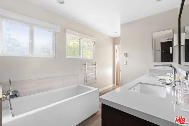 a white bath tub sitting next to a white sink