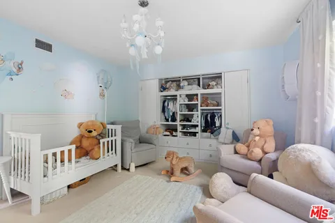 a bedroom with furniture and a large window