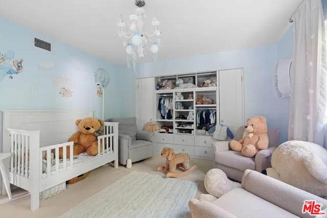 a bedroom with furniture and a large window