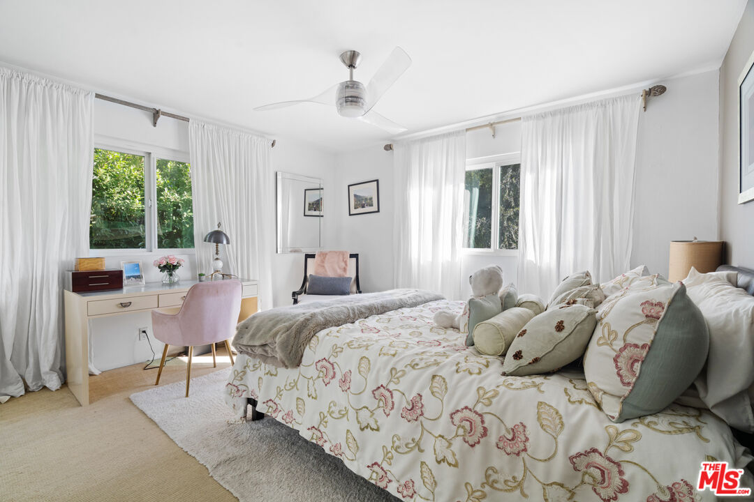 9767 Apricot Lane Beverly Hills, CA 90210 - Photo 19 of 29 a bedroom with a bed and large windows