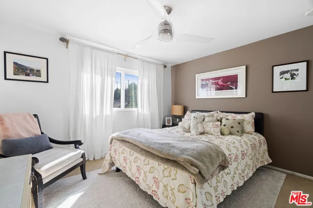 a bedroom with bed and a window