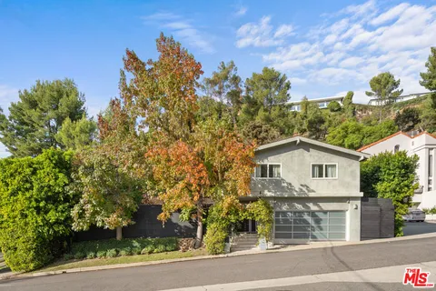a view of a house with a yard and tree s