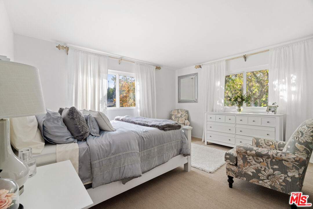 9767 Apricot Lane Beverly Hills, CA 90210 - Photo 21 of 29 a bedroom with a bed and windows