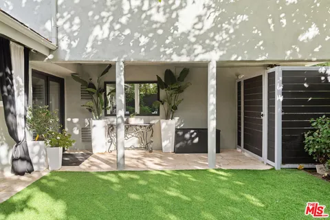 a view of a house with a yard and sitting area