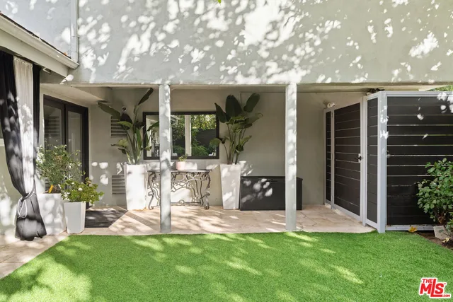 a view of a house with a yard and sitting area