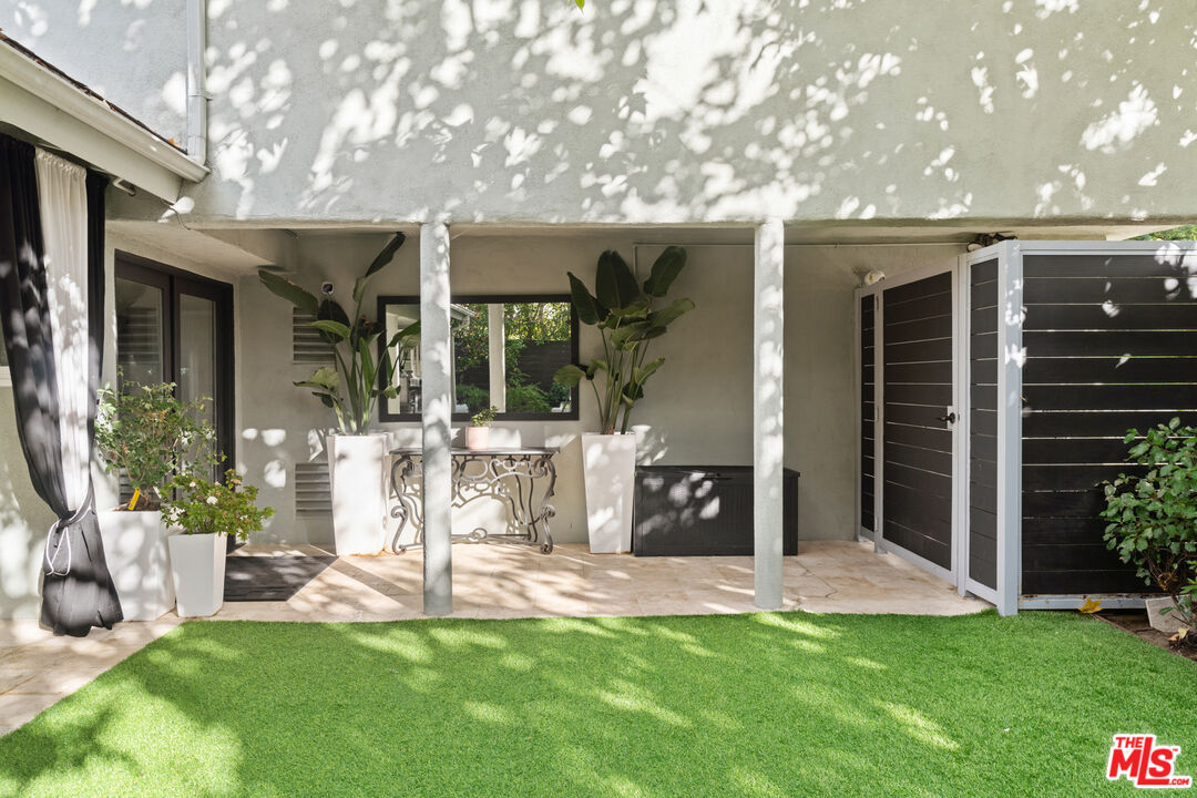 9767 Apricot Lane Beverly Hills, CA 90210 - Photo 7 of 29 a view of a house with a yard and sitting area