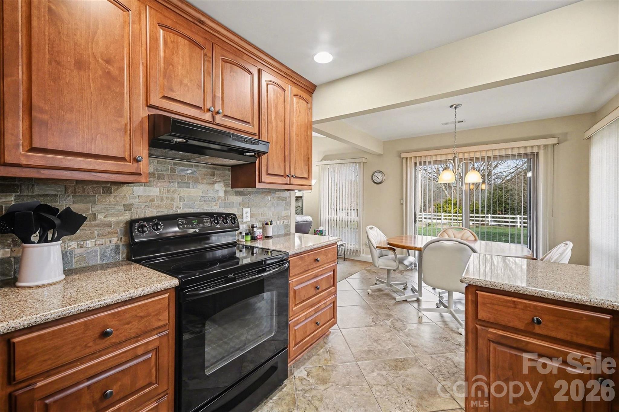 9325 Chislehurst Road Mint Hill, NC 28227 - Photo 13 of 30 a kitchen with stainless steel appliances granite countertop a stove a sink and a microwave