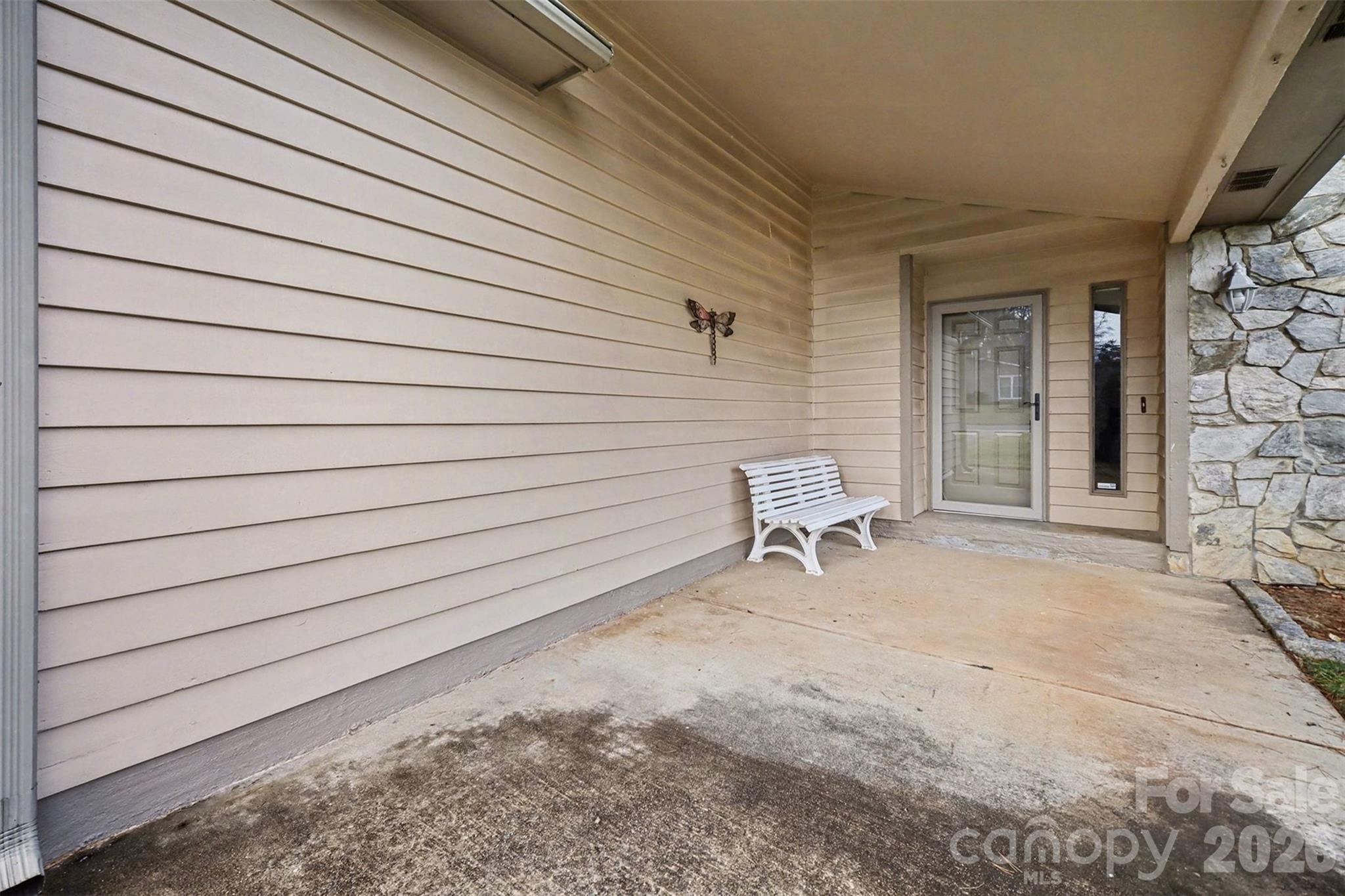 9325 Chislehurst Road Mint Hill, NC 28227 - Photo 30 of 30 a white bench sitting in front of a building
