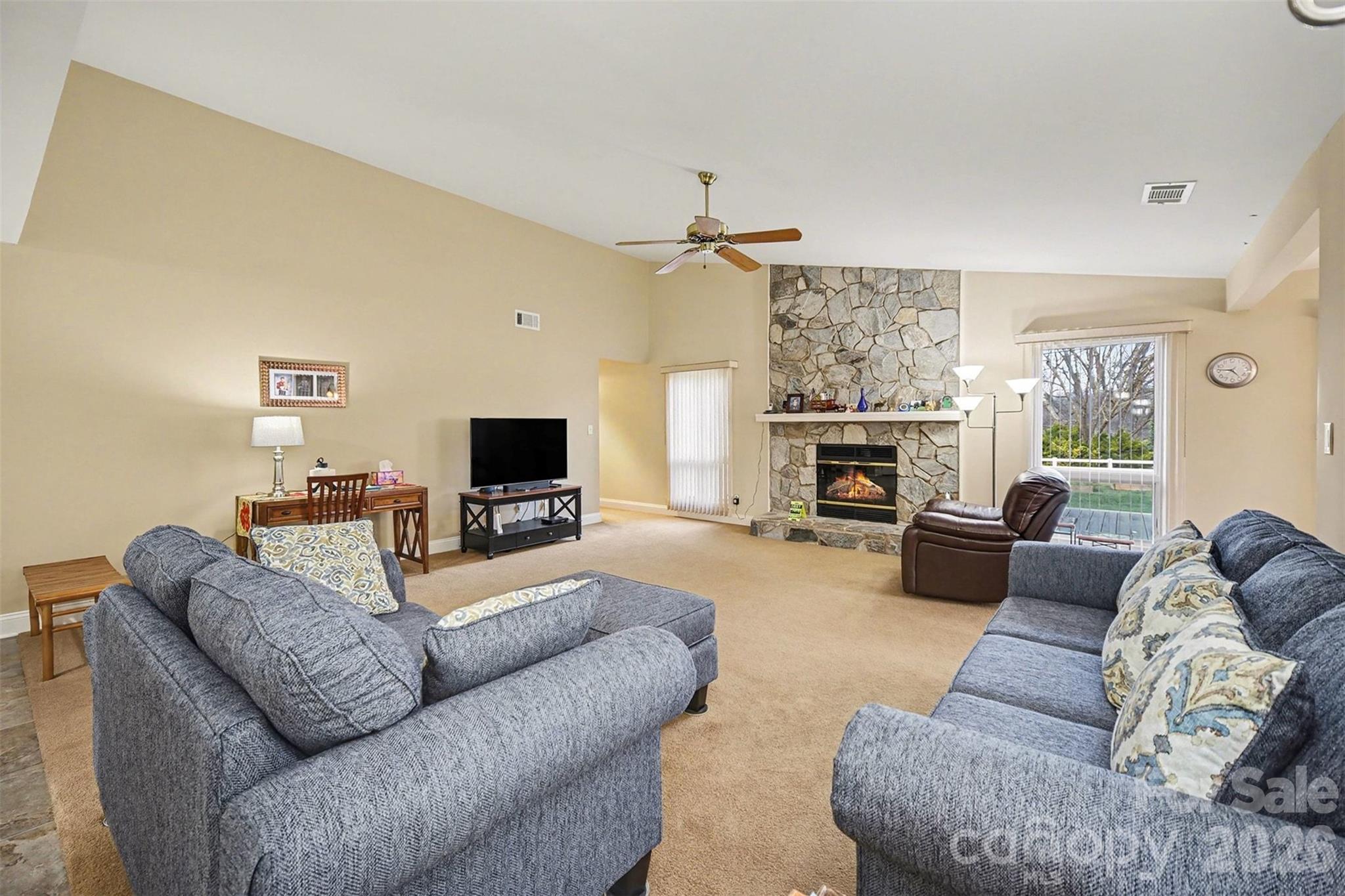9325 Chislehurst Road Mint Hill, NC 28227 - Photo 6 of 30 a living room with furniture a flat screen tv and a fireplace