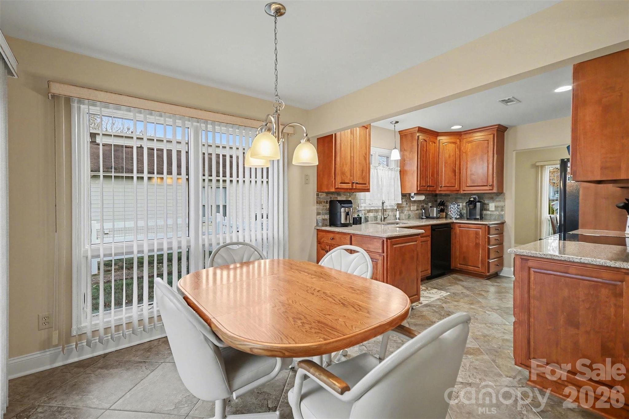 9325 Chislehurst Road Mint Hill, NC 28227 - Photo 8 of 30 a kitchen with a table chairs stainless steel appliances and cabinets