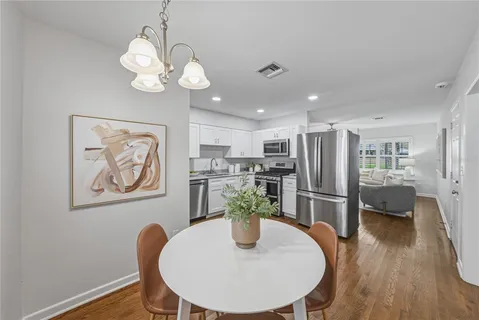 a kitchen with stainless steel appliances a stove a refrigerator and a refrigerator