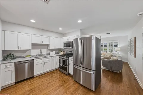 a kitchen with stainless steel appliances a refrigerator stove and sink
