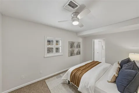 a bedroom with a bed and a lamp