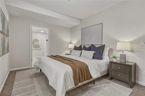 a bedroom with a bed and a painting on the wall