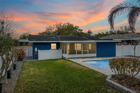 a view of a backyard with swimming pool