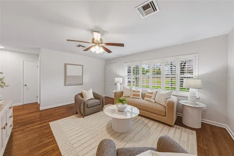 a living room with furniture and a potted plant