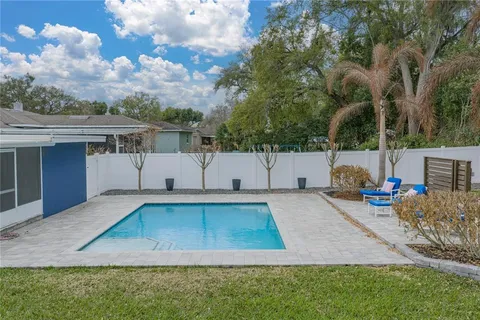 an aerial view of a house with yard swimming pool and outdoor seating