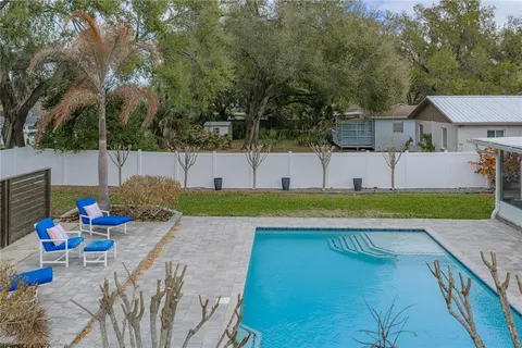 an aerial view of a residential houses with outdoor space and lake view