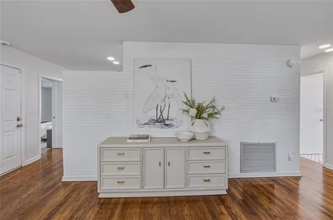 a kitchen with stainless steel appliances granite countertop a stove a sink a refrigerator dining table and chairs