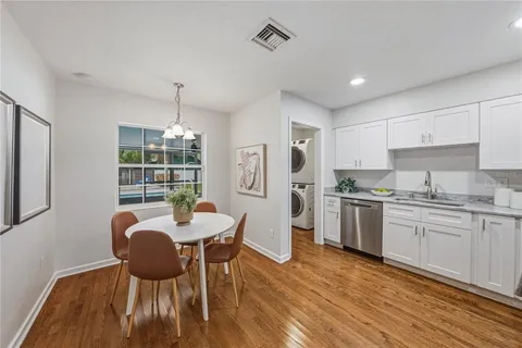a view of a dining room with furniture wooden floor and chandelier