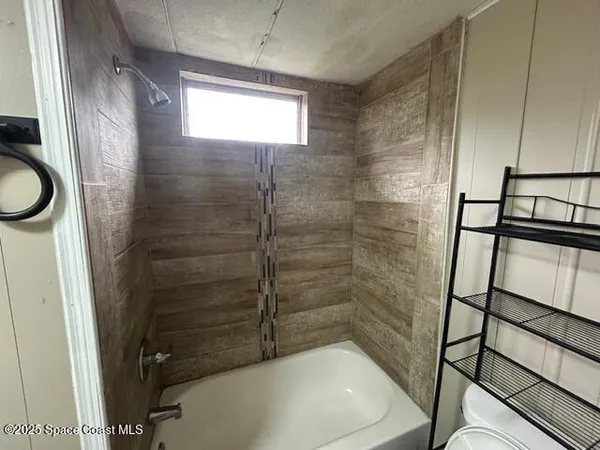 a bathroom with a bathtub and shower