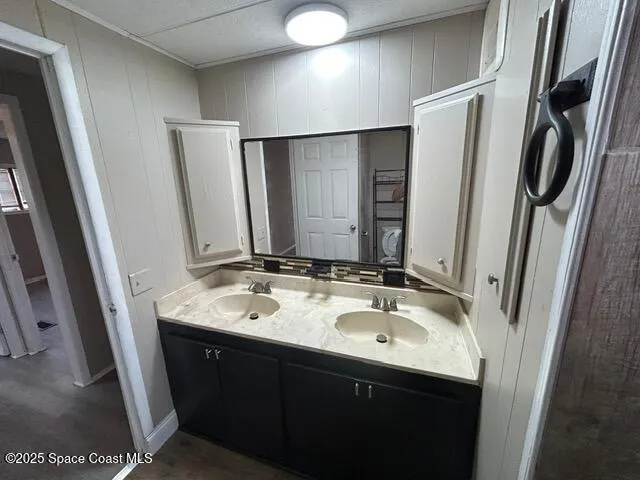 a bathroom with a double vanity sink and a mirror