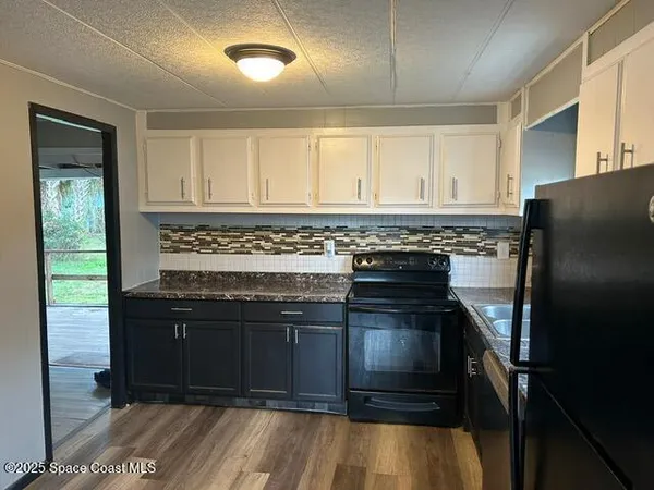 a kitchen with a stove and a refrigerator