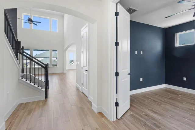 a view of a hallway with wooden floor and staircase