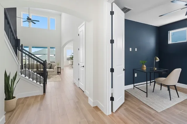 a view of a hallway with wooden floor and furniture