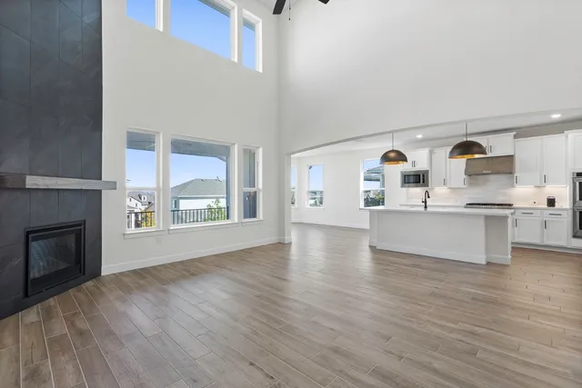 a large kitchen with cabinets and wooden floor